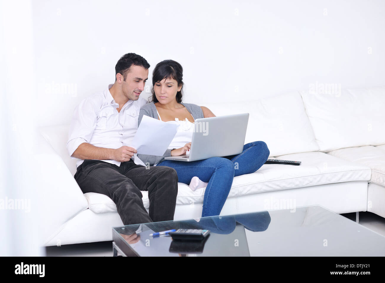 joyful couple relax and work on laptop computer at modern home Stock Photo