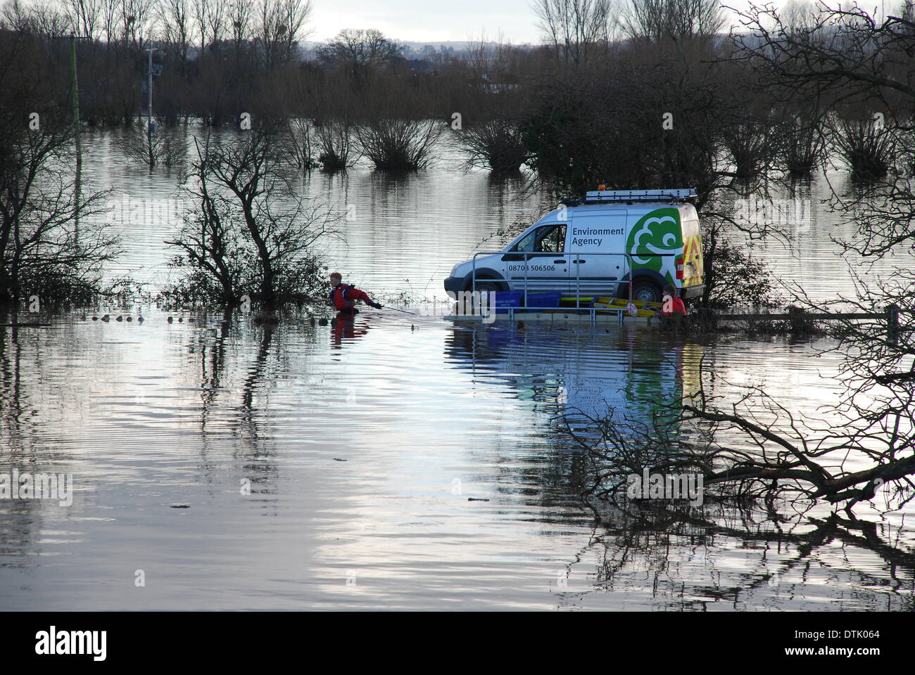 Burrow Bridge, Somerset, UK. 18th February 2014. 18 February 2014 Flooding on the Somerset Levels Somerset UK. Burrow Bridge. Environment Agency employees float their van on a pontoon raft along a road flooded chest deep Credit:  Anthony Collins/Alamy Live News Stock Photo