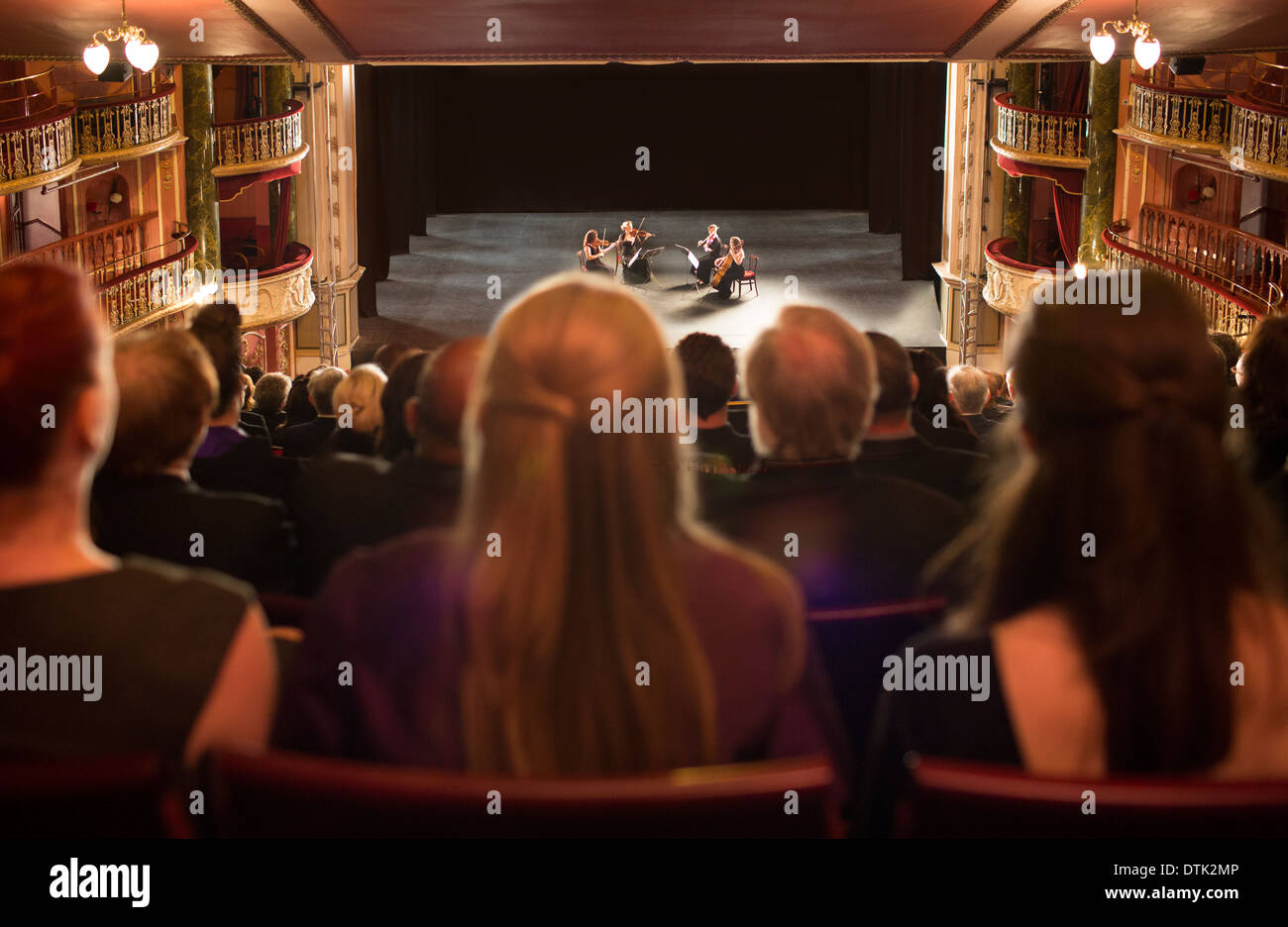 Audience watching quarter perform on stage in theater Stock Photo