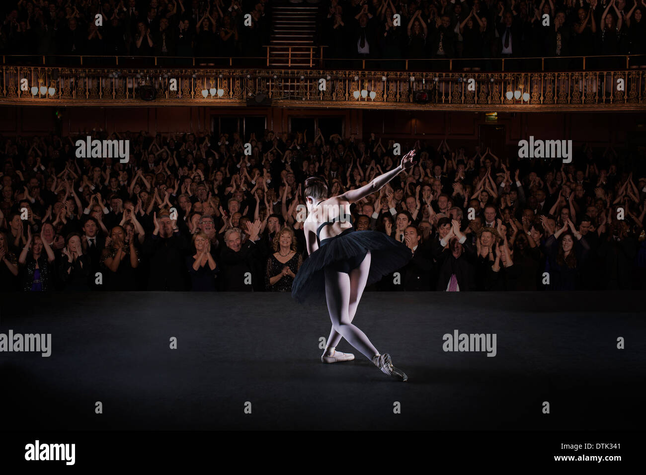 Ballerina bowing on stage in theater Stock Photo
