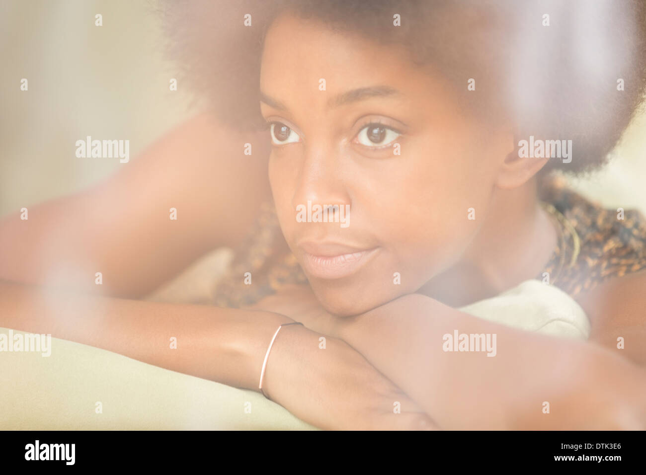 Woman resting chin in hands Stock Photo