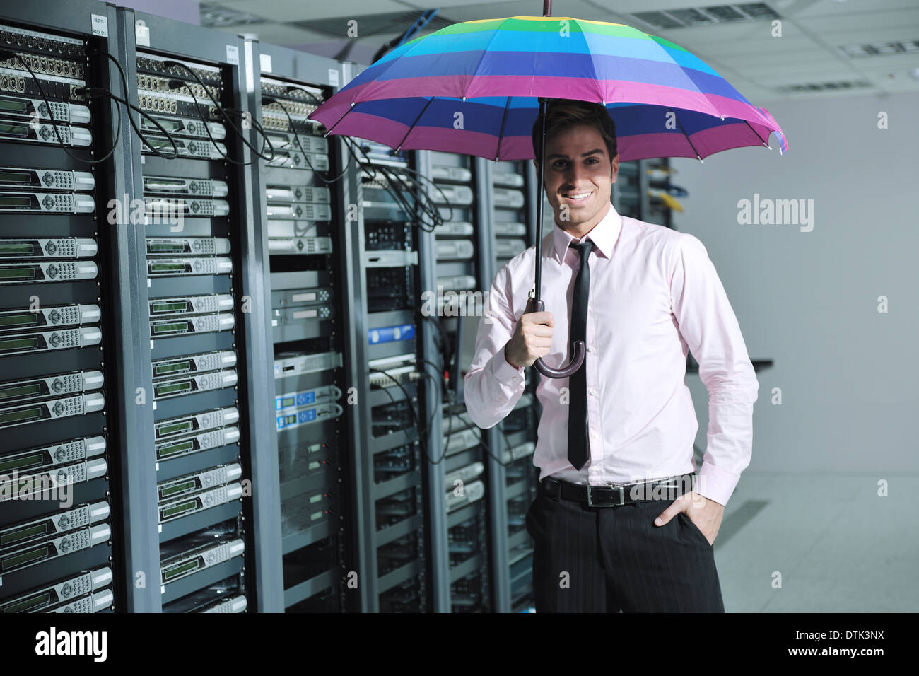 businessman hold umbrella in server room Stock Photo Alamy