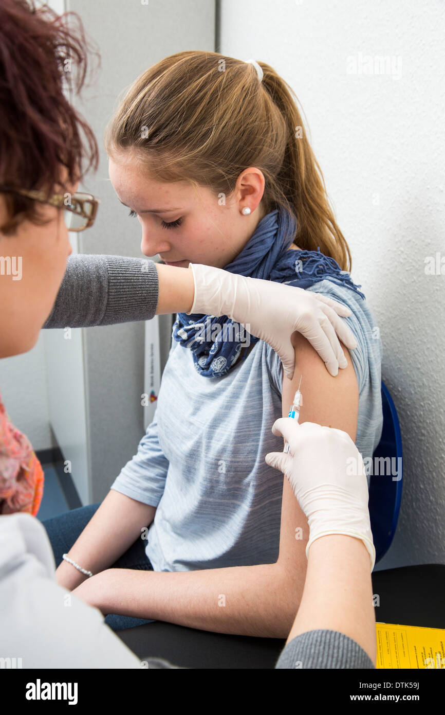Doctors office. Young, female patient gets a vaccination. Stock Photo