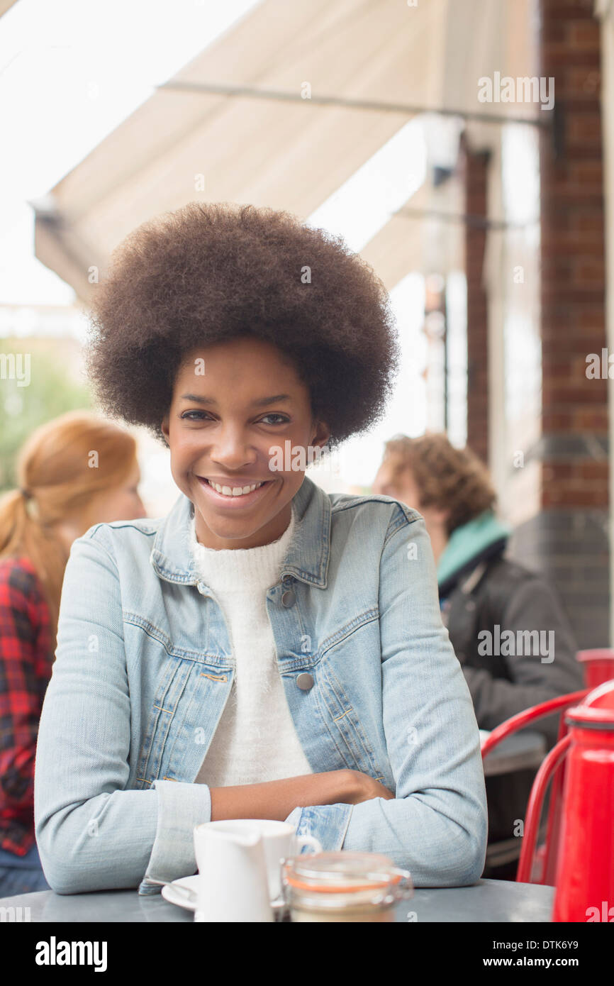 Woman drinking cup of coffee at sidewalk cafe Stock Photo Alamy