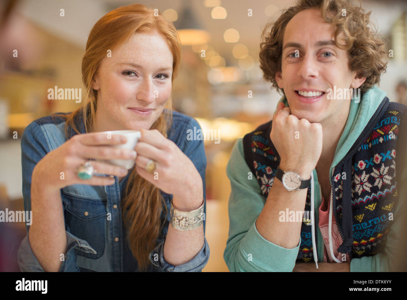 Couple smiling together in cafe Stock Photo