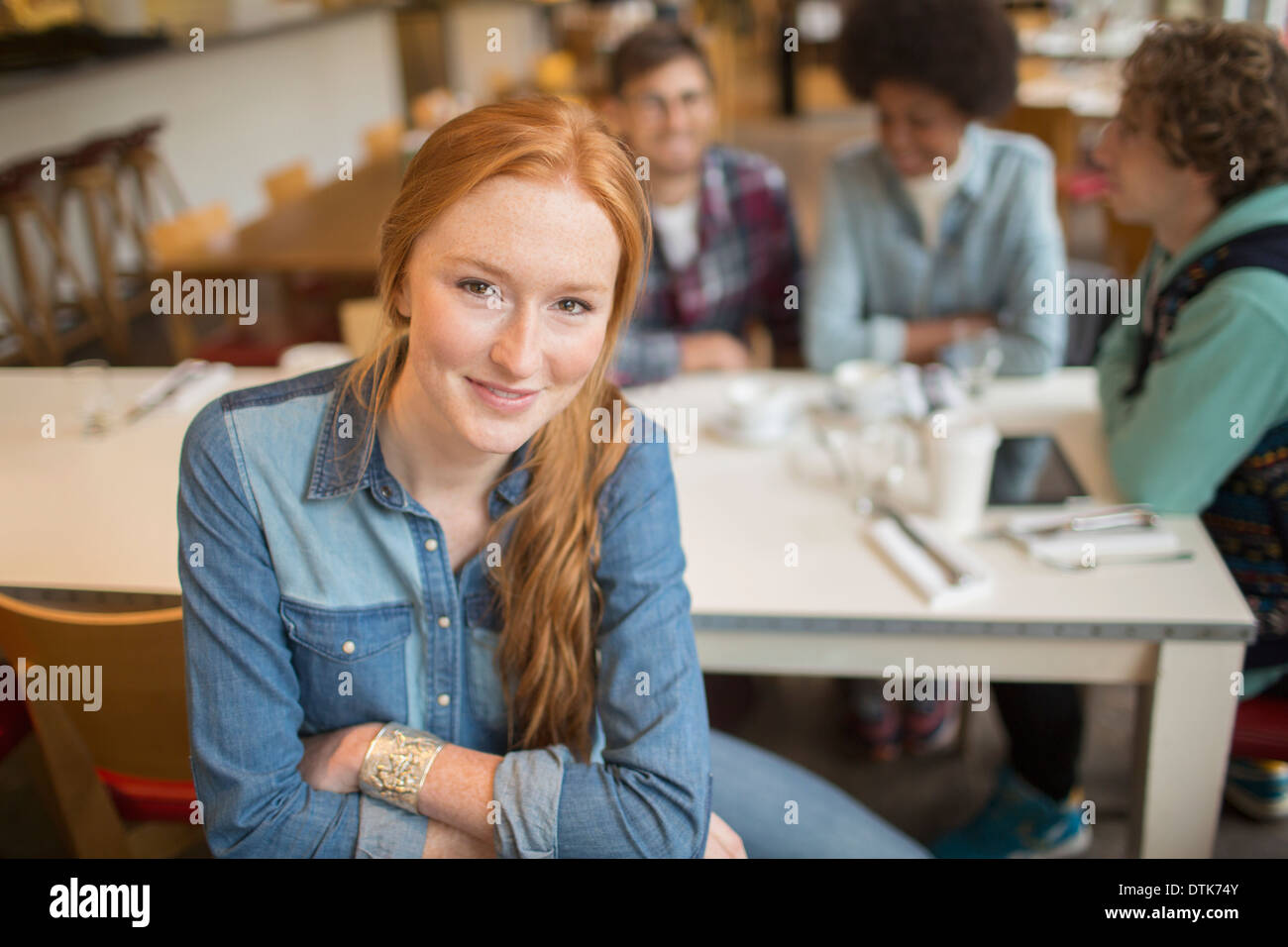 Woman sitting with friends in cafe Stock Photo