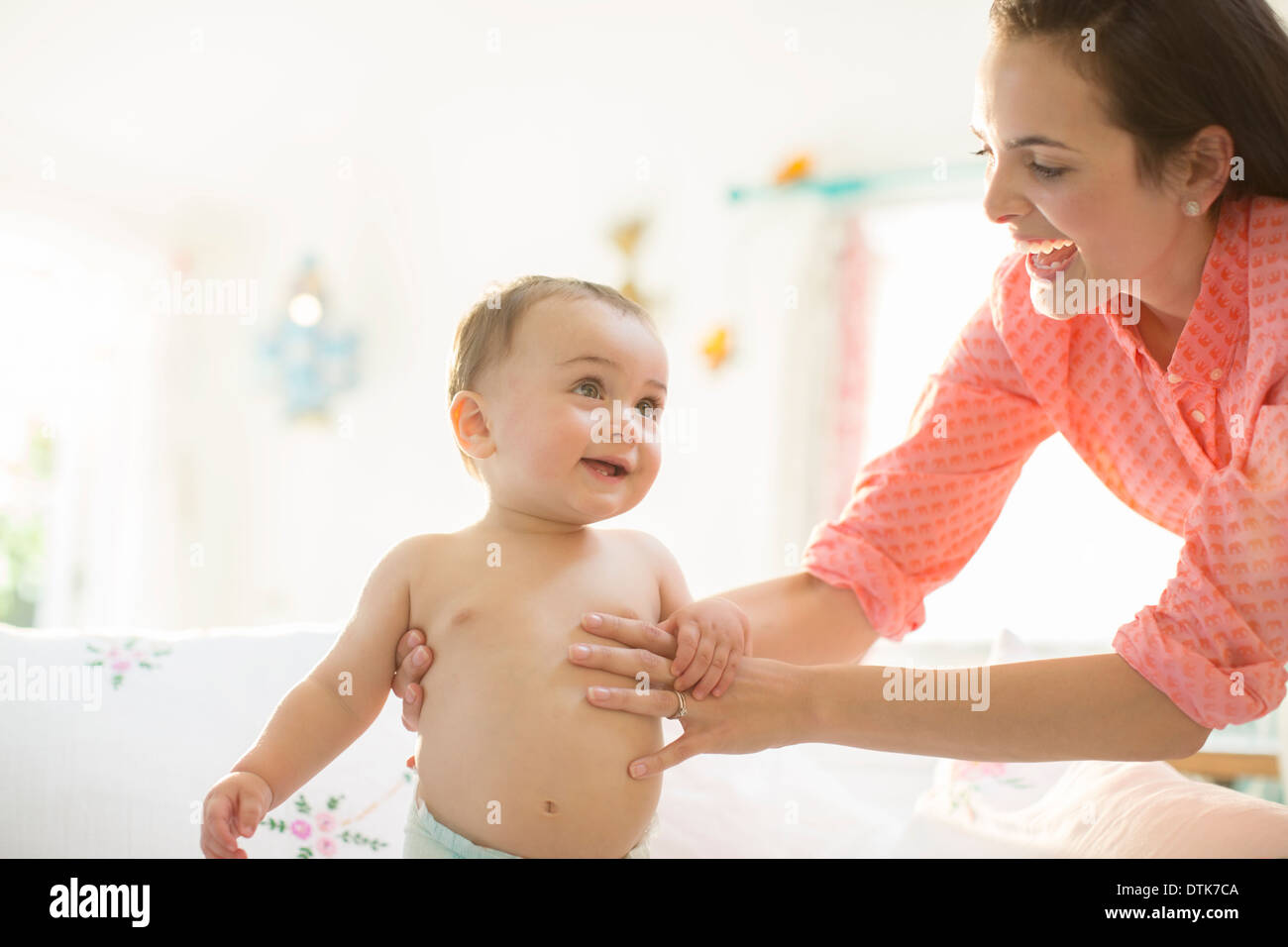 Adult helping two young children hires stock photography and images