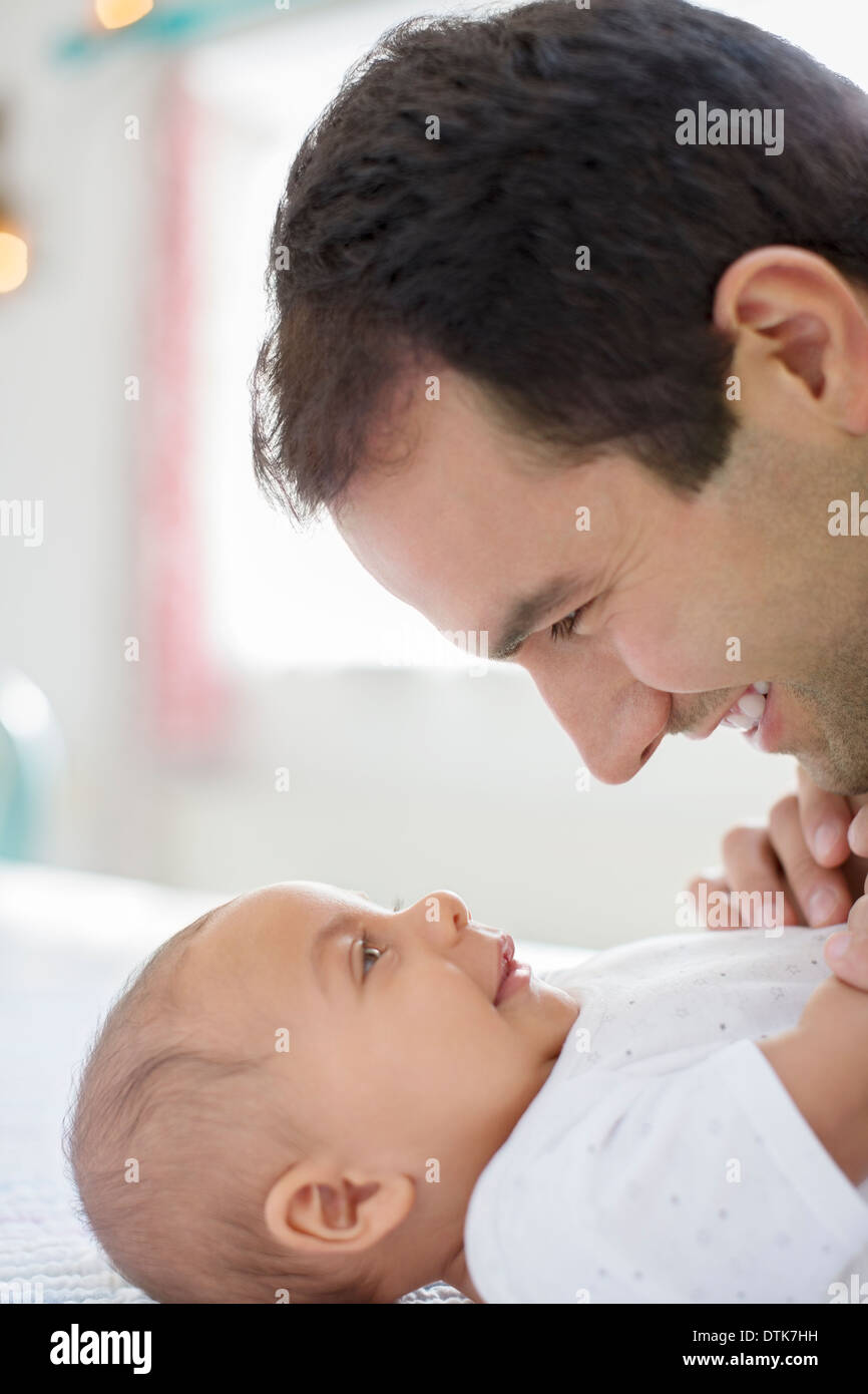 Father adoring baby boy on table Stock Photo