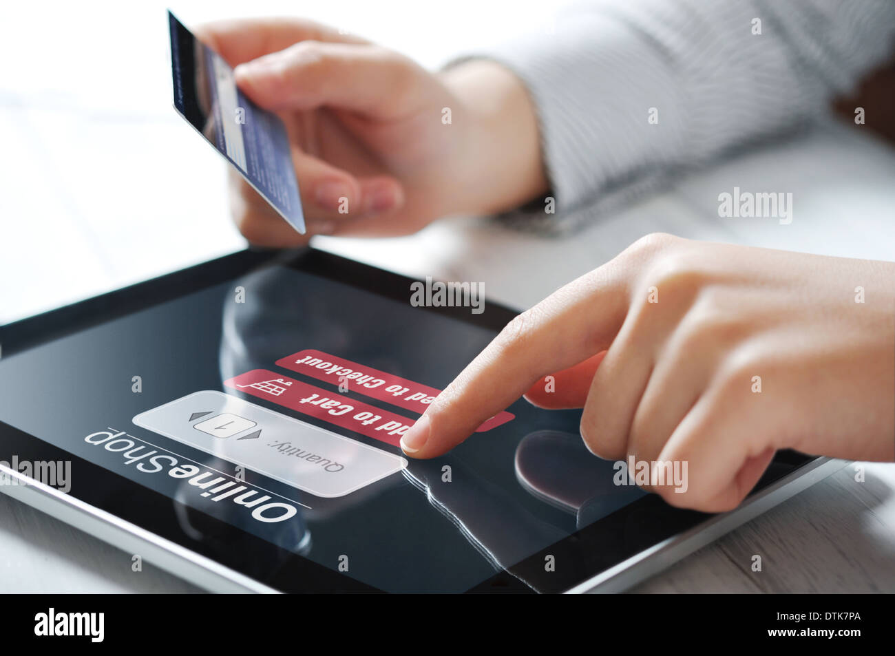 Female hands using touch screen device for online payment Stock Photo