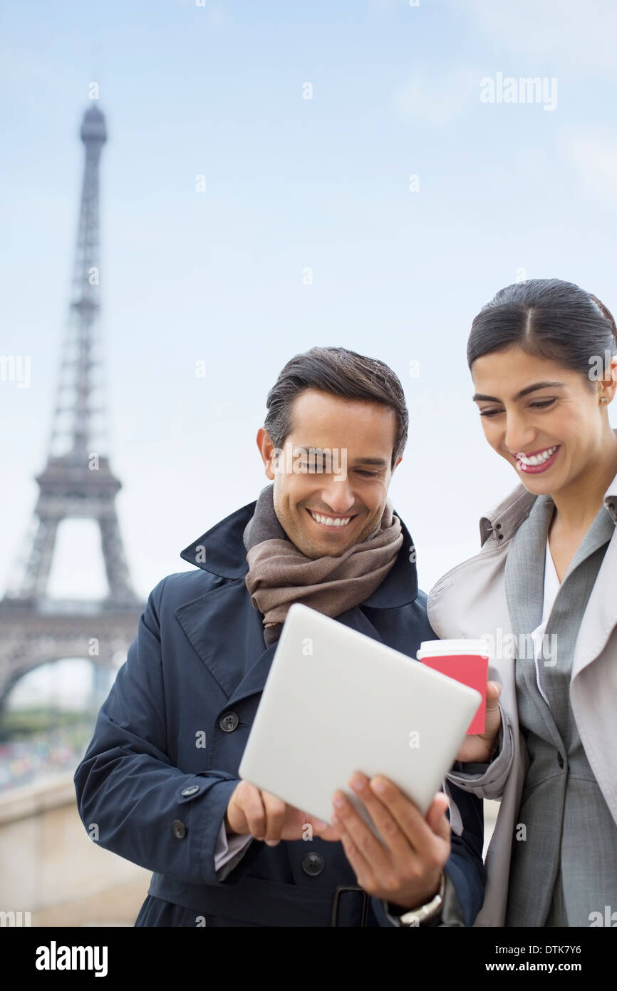 Business people using digital tablet near Eiffel Tower, Paris, France Stock Photo