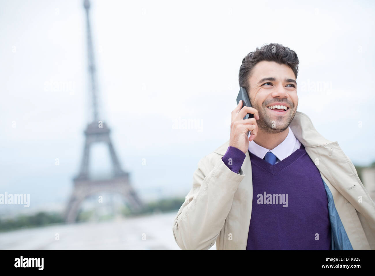 Businessman talking on cell phone by Eiffel Tower Stock Photo