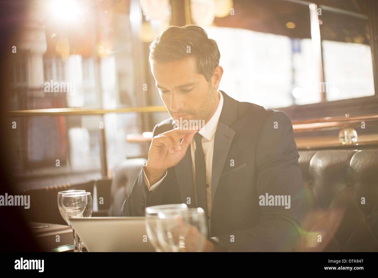Businessman using digital tablet in restaurant Stock Photo