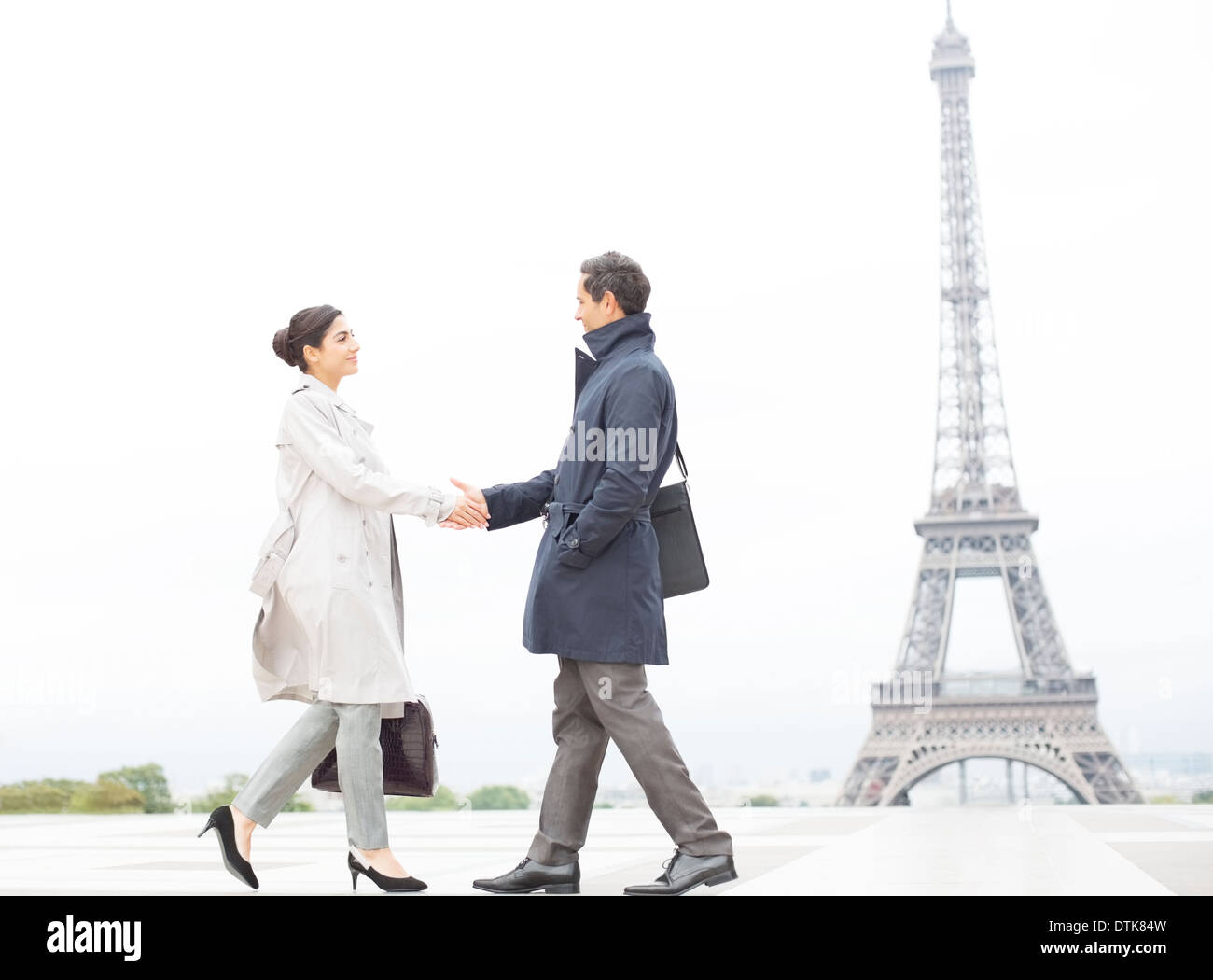 Business people shaking hands near Eiffel Tower, Paris, France Stock Photo