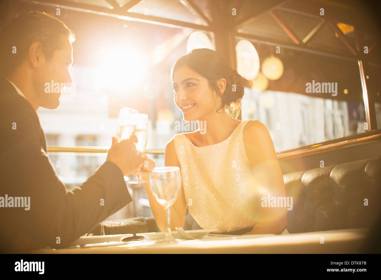 Couple toasting champagne flutes in restaurant Stock Photo