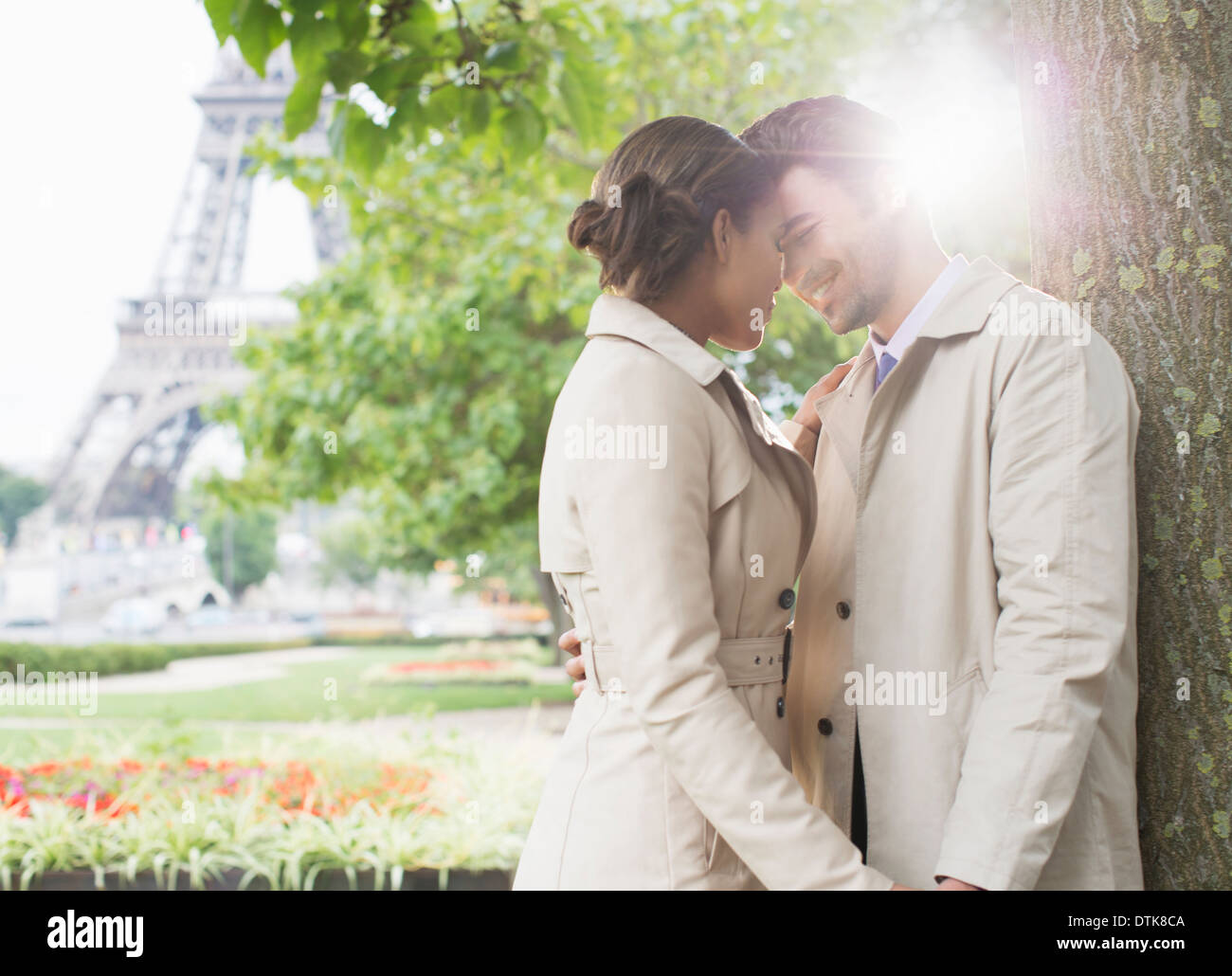 Couple kissing in park near Eiffel Tower, Paris, France Stock Photo