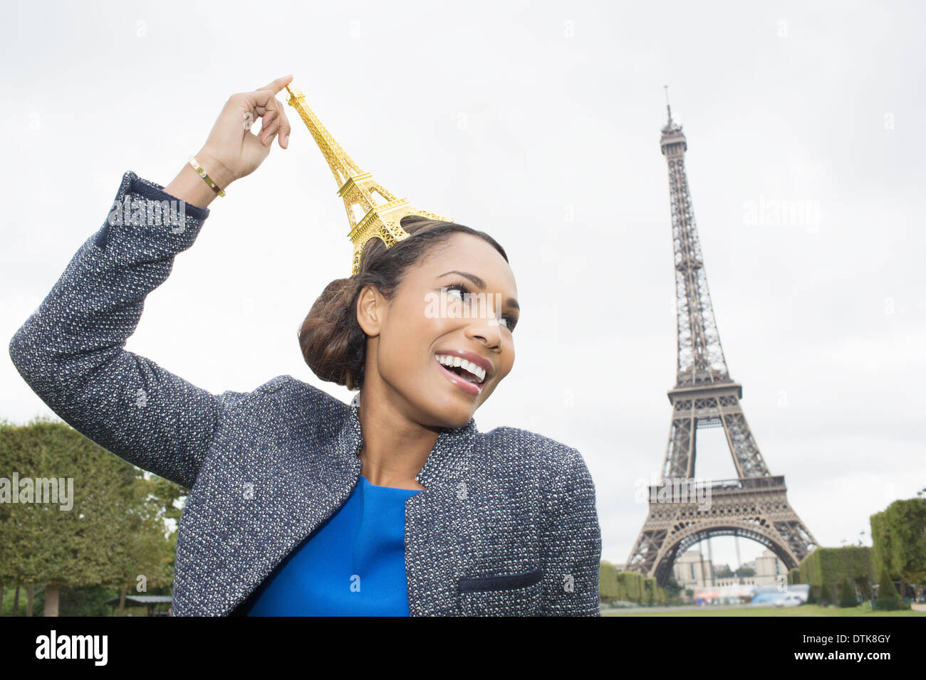 Woman posing with souvenir in front of Eiffel Tower, Paris, France Stock Photo
