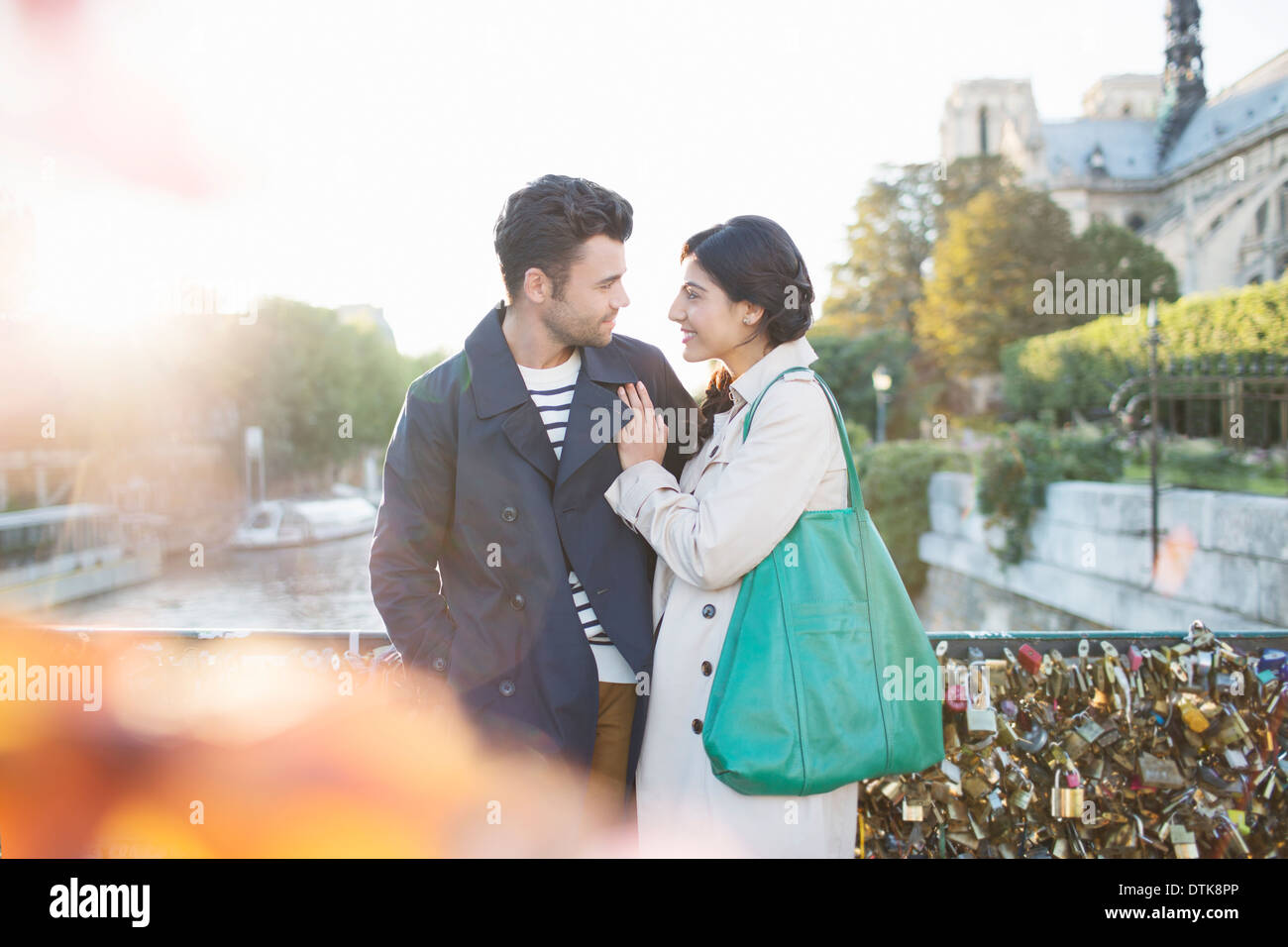 Couple standing on Pont des Arts bridge over Seine River, Paris, France Stock Photo