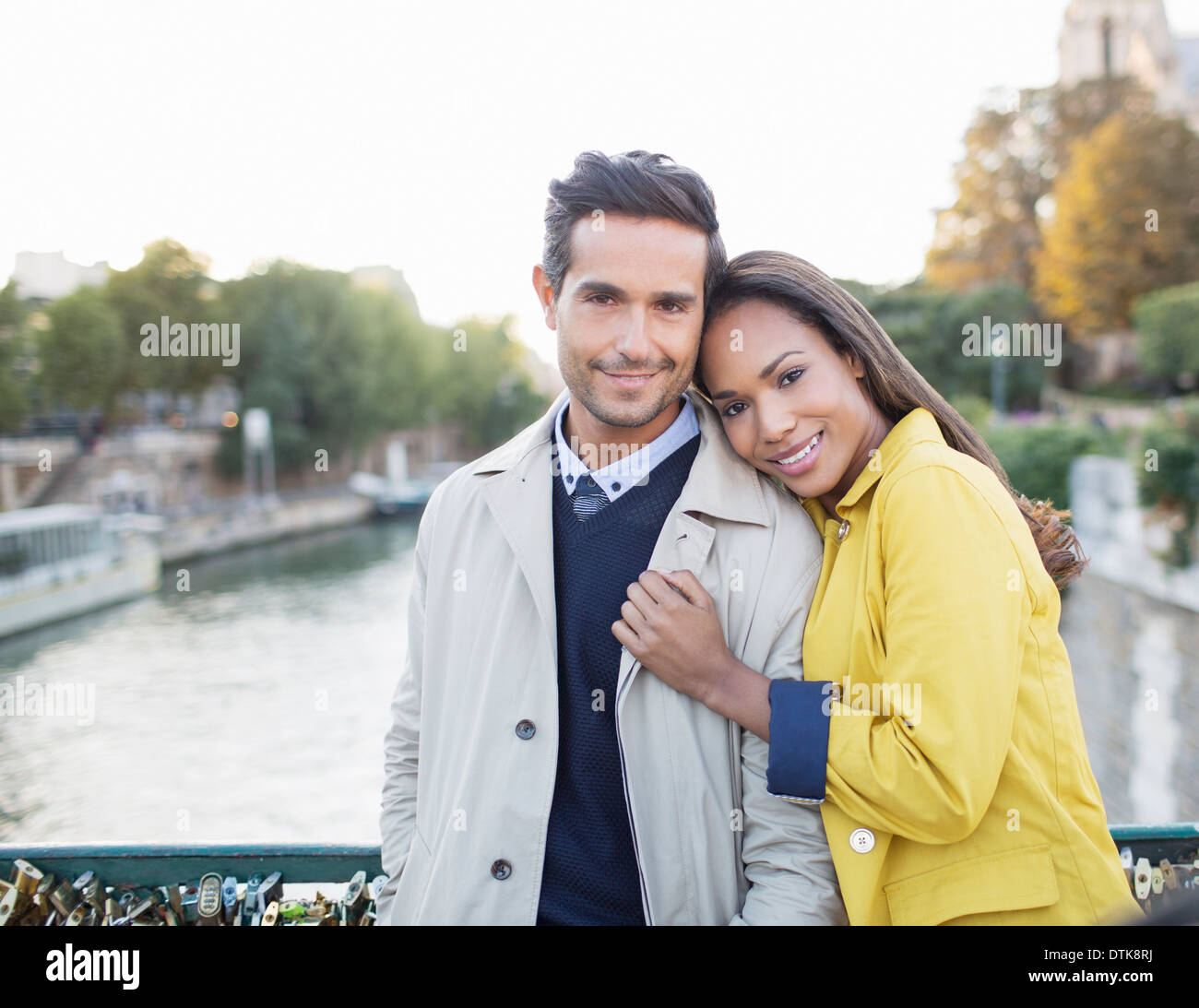 Couple hugging on Pont des Arts bridge over Seine River, Paris, France Stock Photo