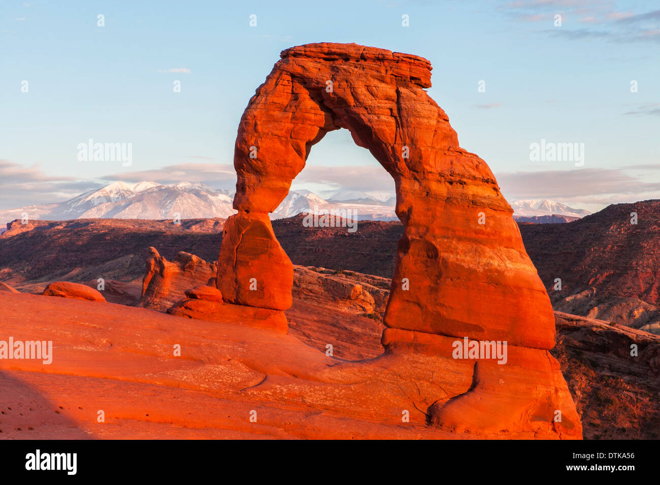 Delicate Arch and the snowclad La Sal Mountains at sunset, Arches