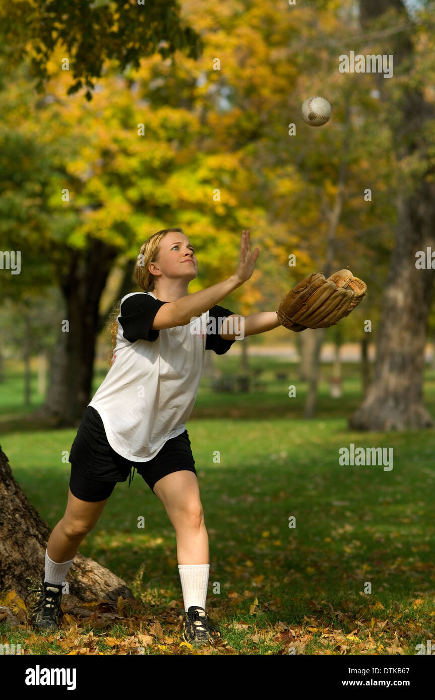 A female softball player catching a ball Stock Photo Alamy