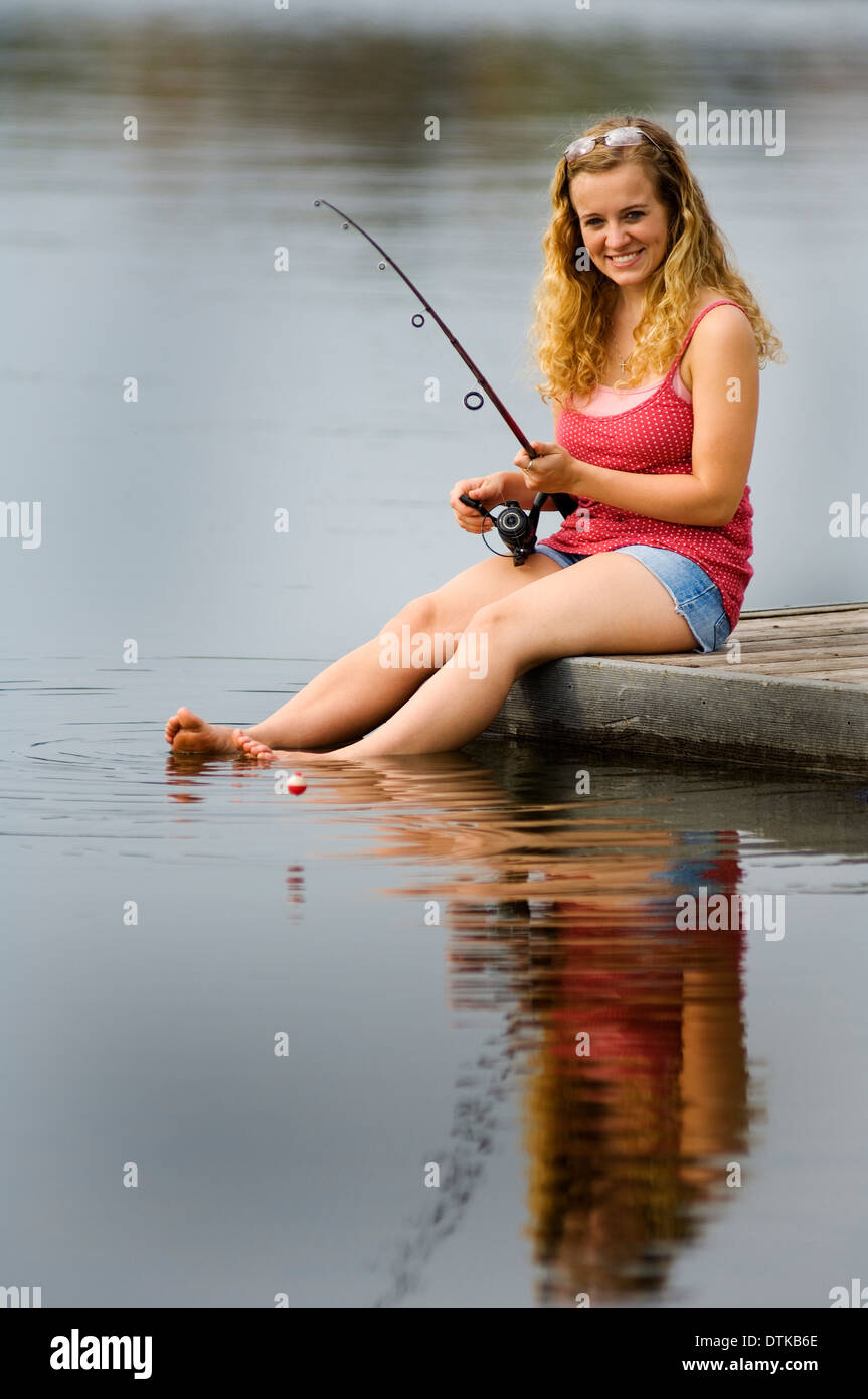 Girl fishing pole young sitting hi-res stock photography and