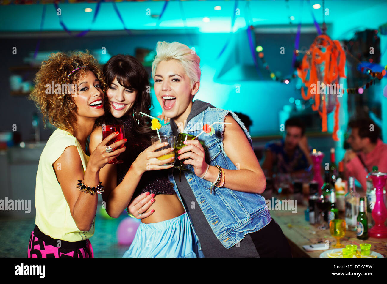 Women enjoying cocktails at party Stock Photo
