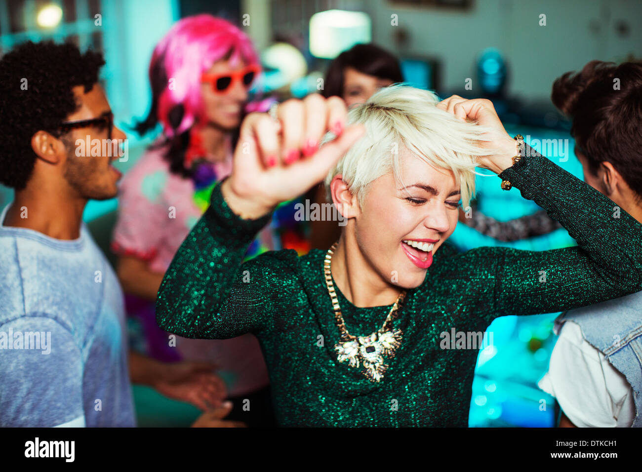 Friends dancing together at party Stock Photo