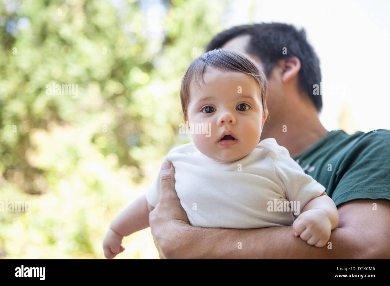 Father carrying baby girl outdoors Stock Photo
