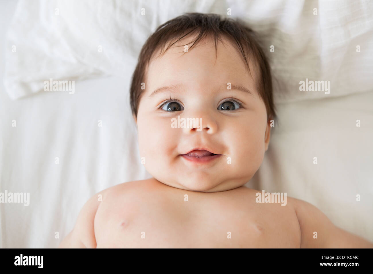 Baby girl laying on bed Stock Photo Alamy