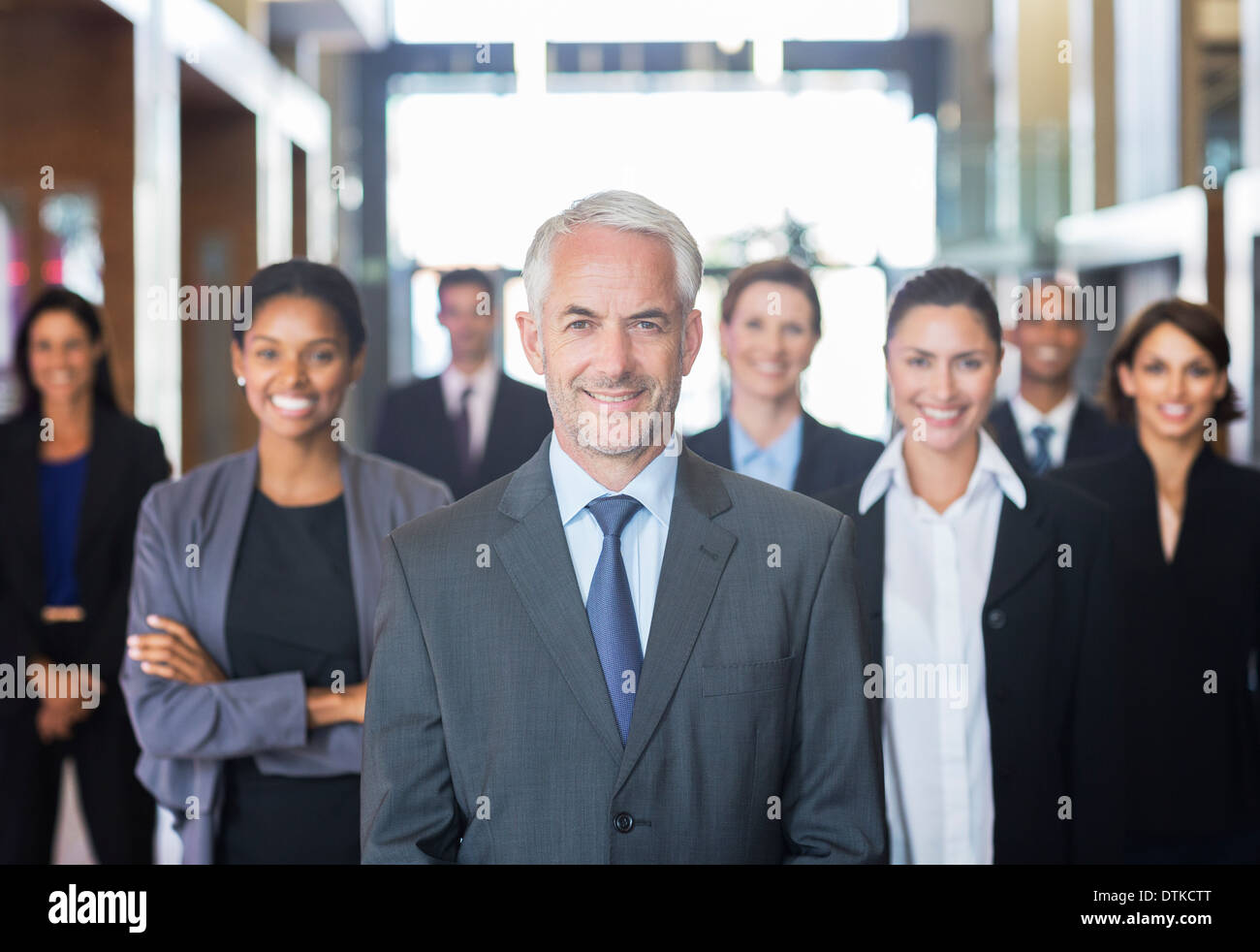 Business people smiling in lobby Stock Photo - Alamy