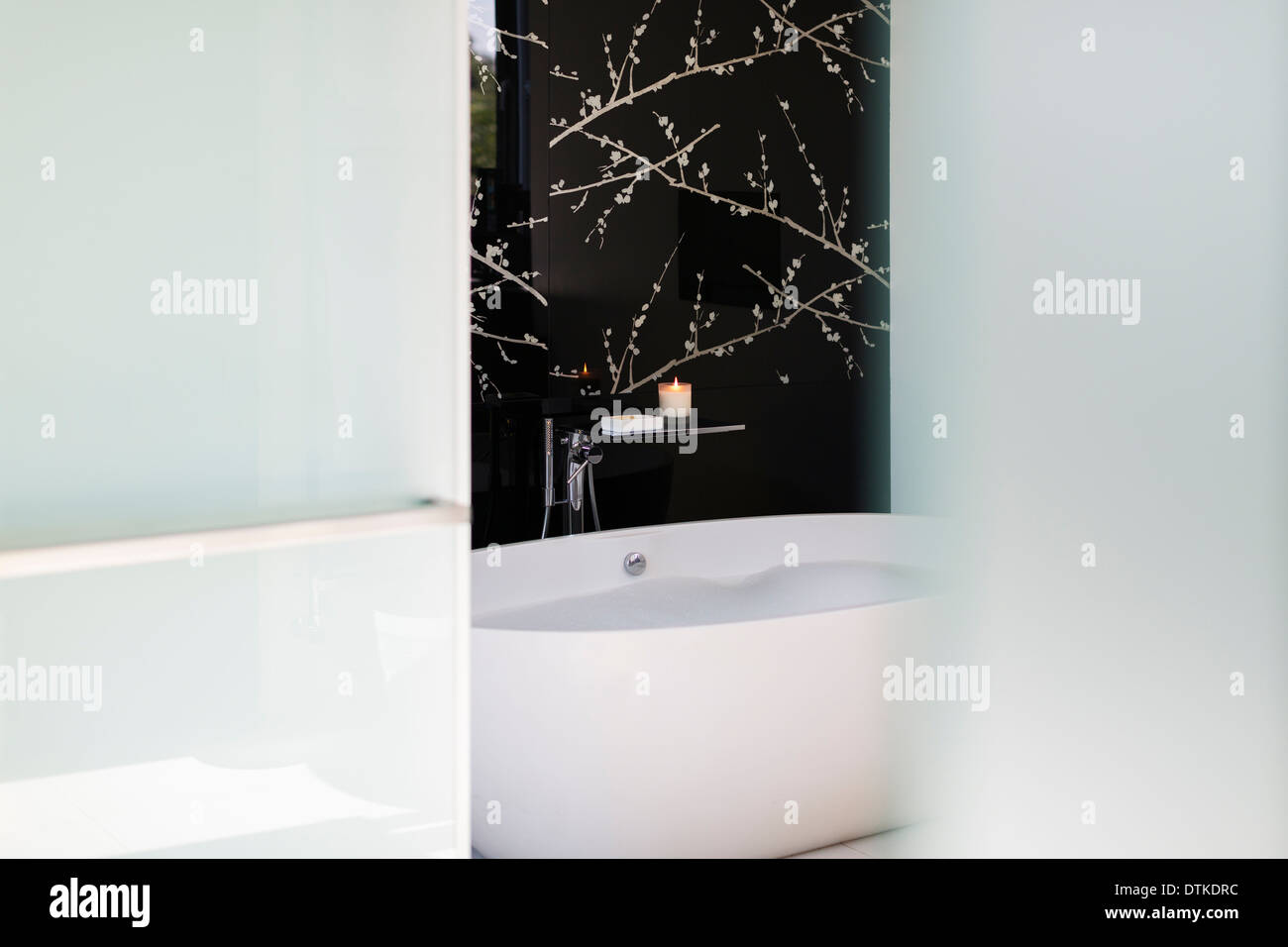 Wall art above soaking tub in modern bathroom Stock Photo - Alamy