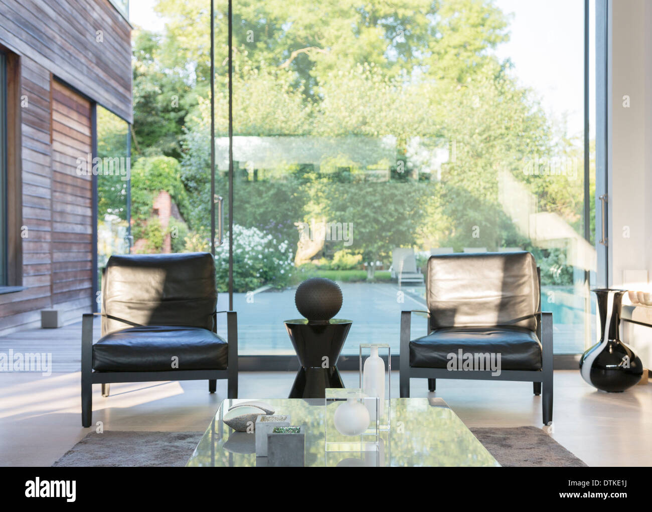 Modern living room overlooking swimming pool Stock Photo