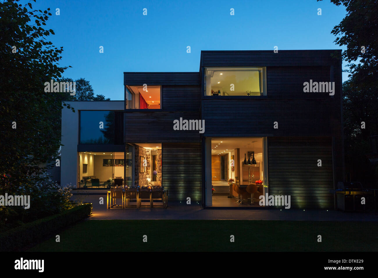 Modern house illuminated at dusk Stock Photo