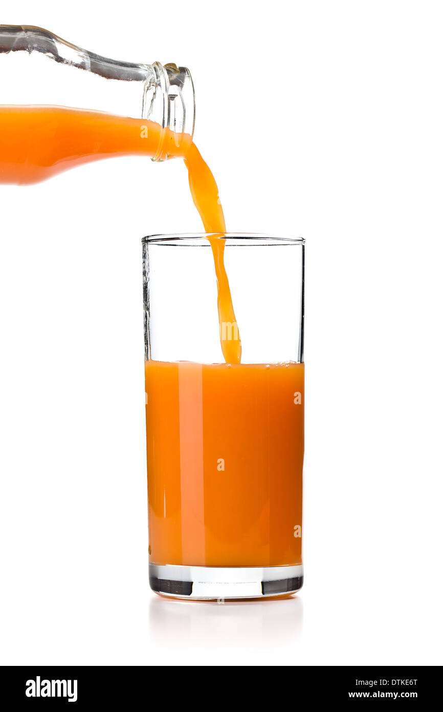the carrot juice pouring into glass Stock Photo