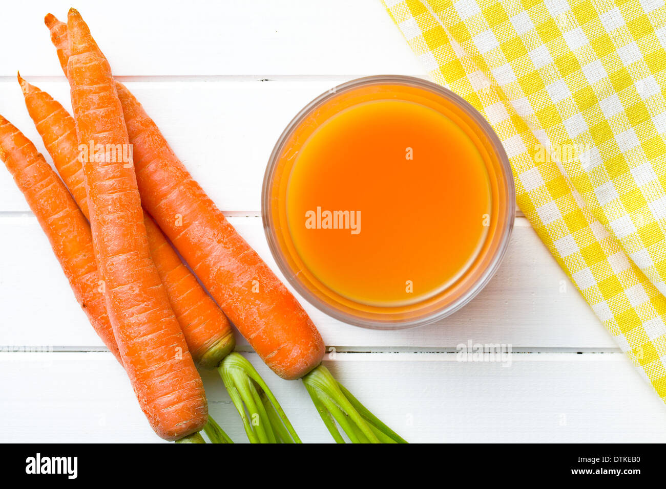 top view of carrot juice in glass on kitchen table Stock Photo