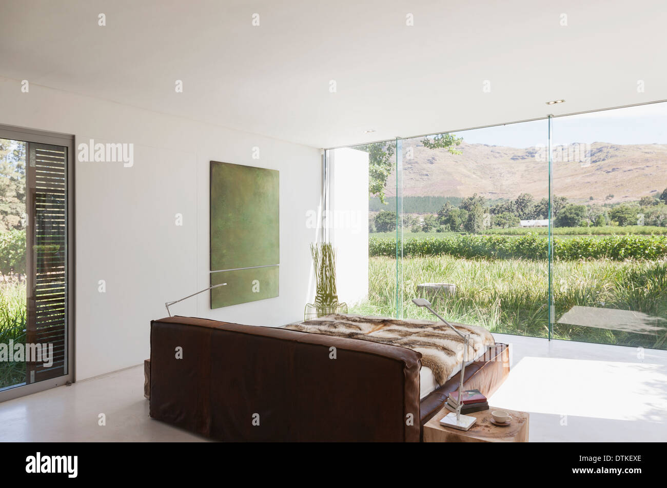 Bedroom in modern house overlooking rural landscape Stock Photo