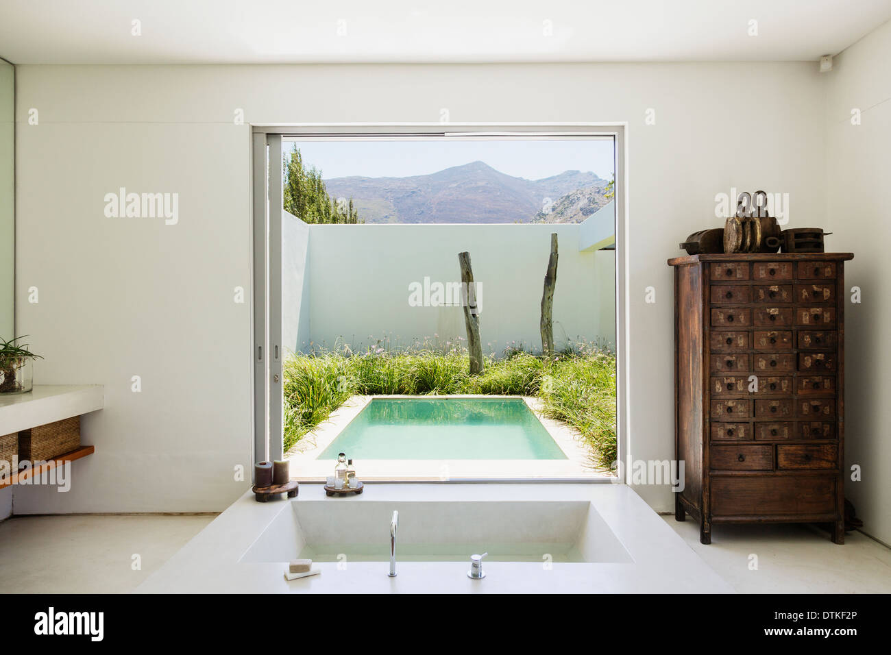 Modern bathroom overlooking luxury soaking pool Stock Photo