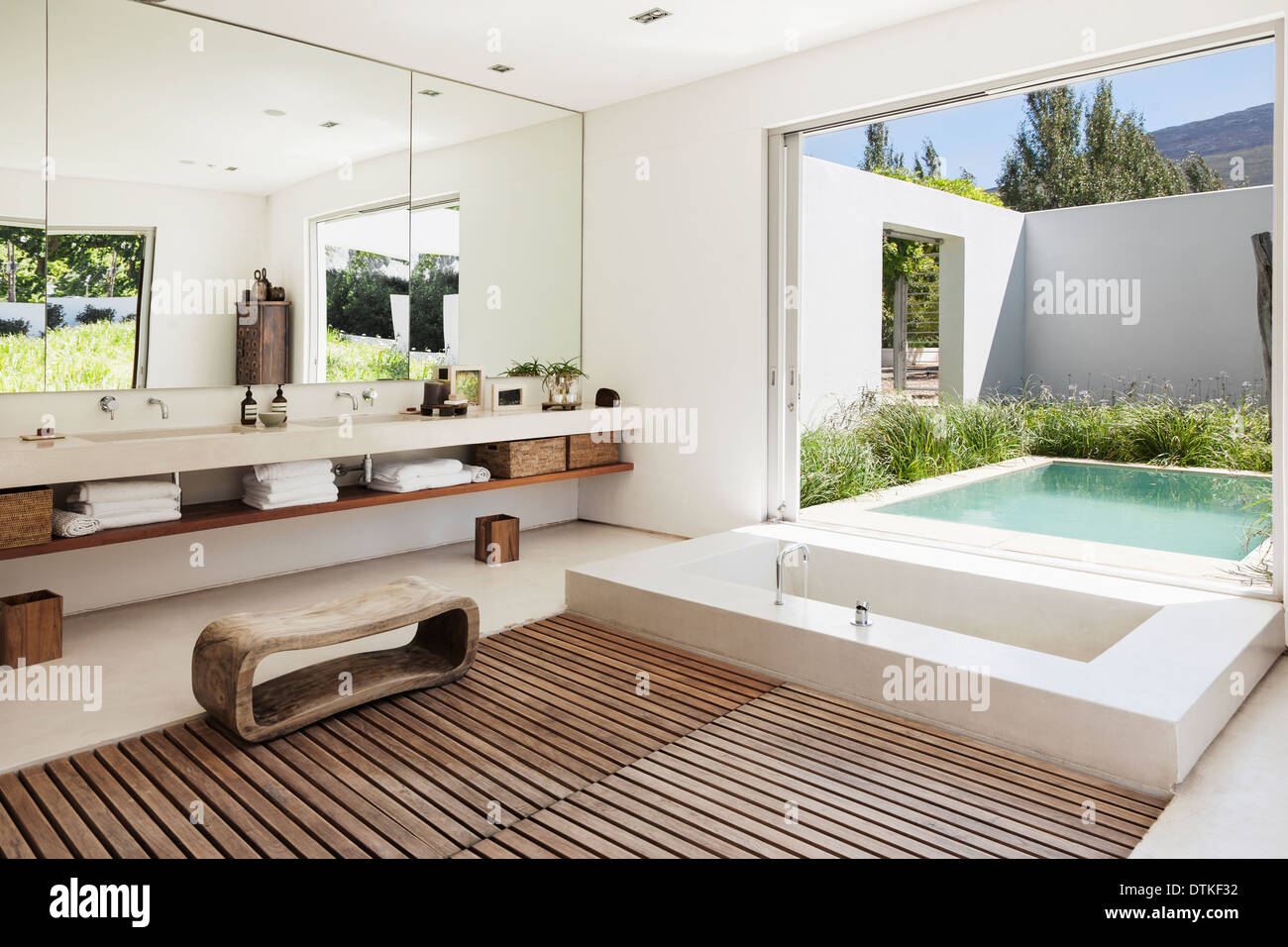 Modern bathroom overlooking luxury soaking pool Stock Photo