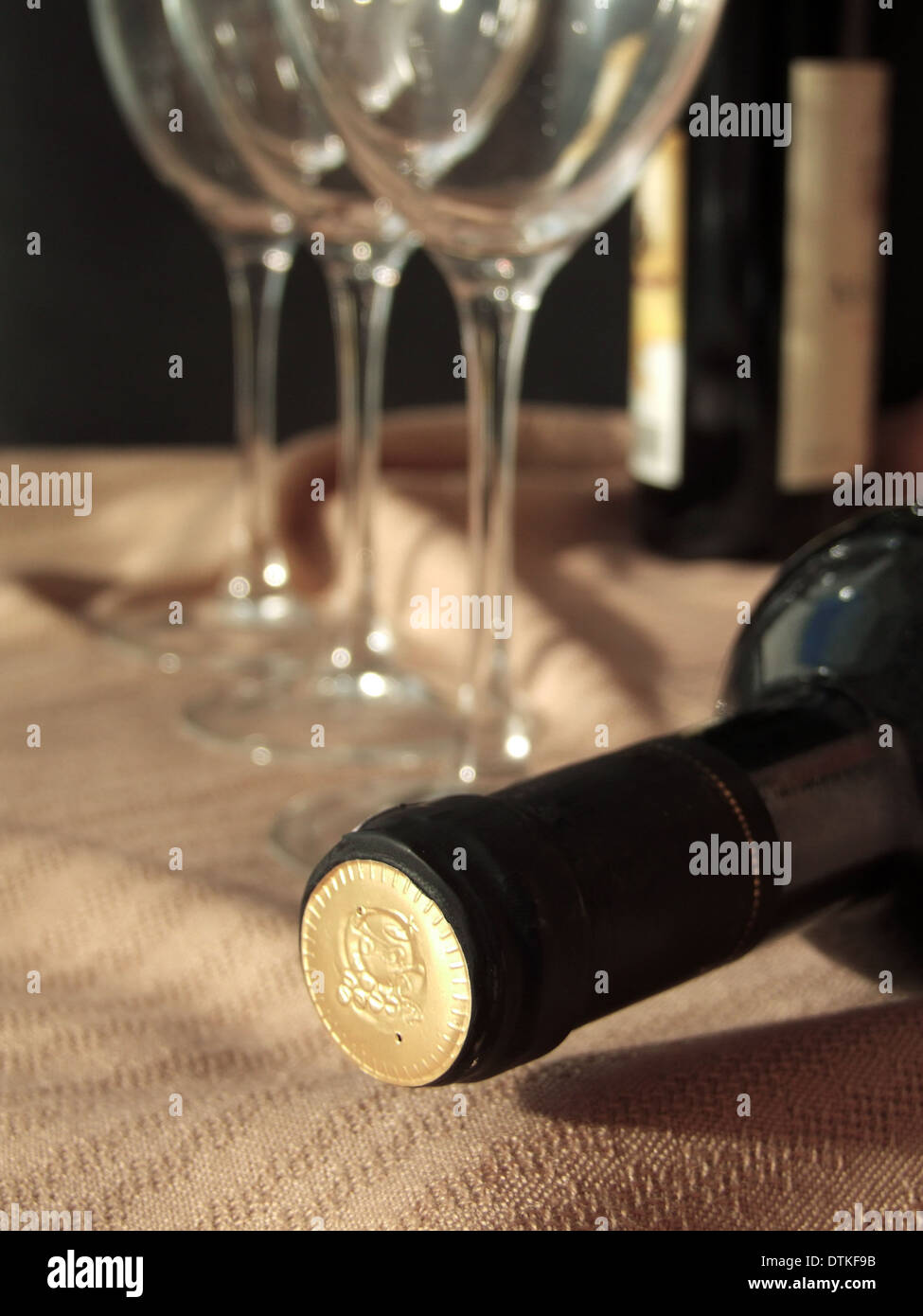 Bottle of wine laying behind the wine glasses Stock Photo Alamy