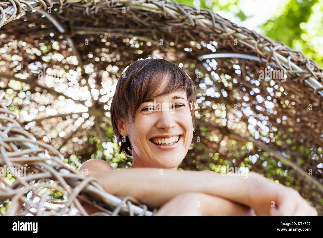Woman laughing in tree house Stock Photo