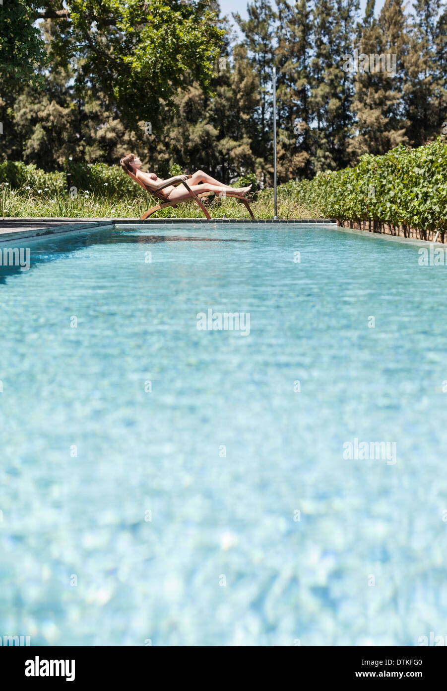 Woman Striped Bikini Lounge Tanning Sunscreen Swimming Pool Stock Photo by  ©elenachhil 189452664