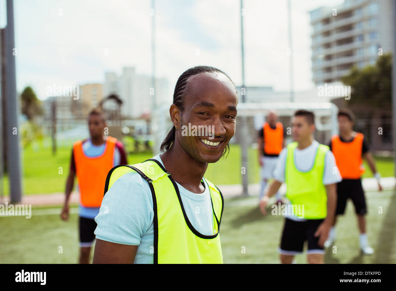 Soccer player smiling on field Stock Photo