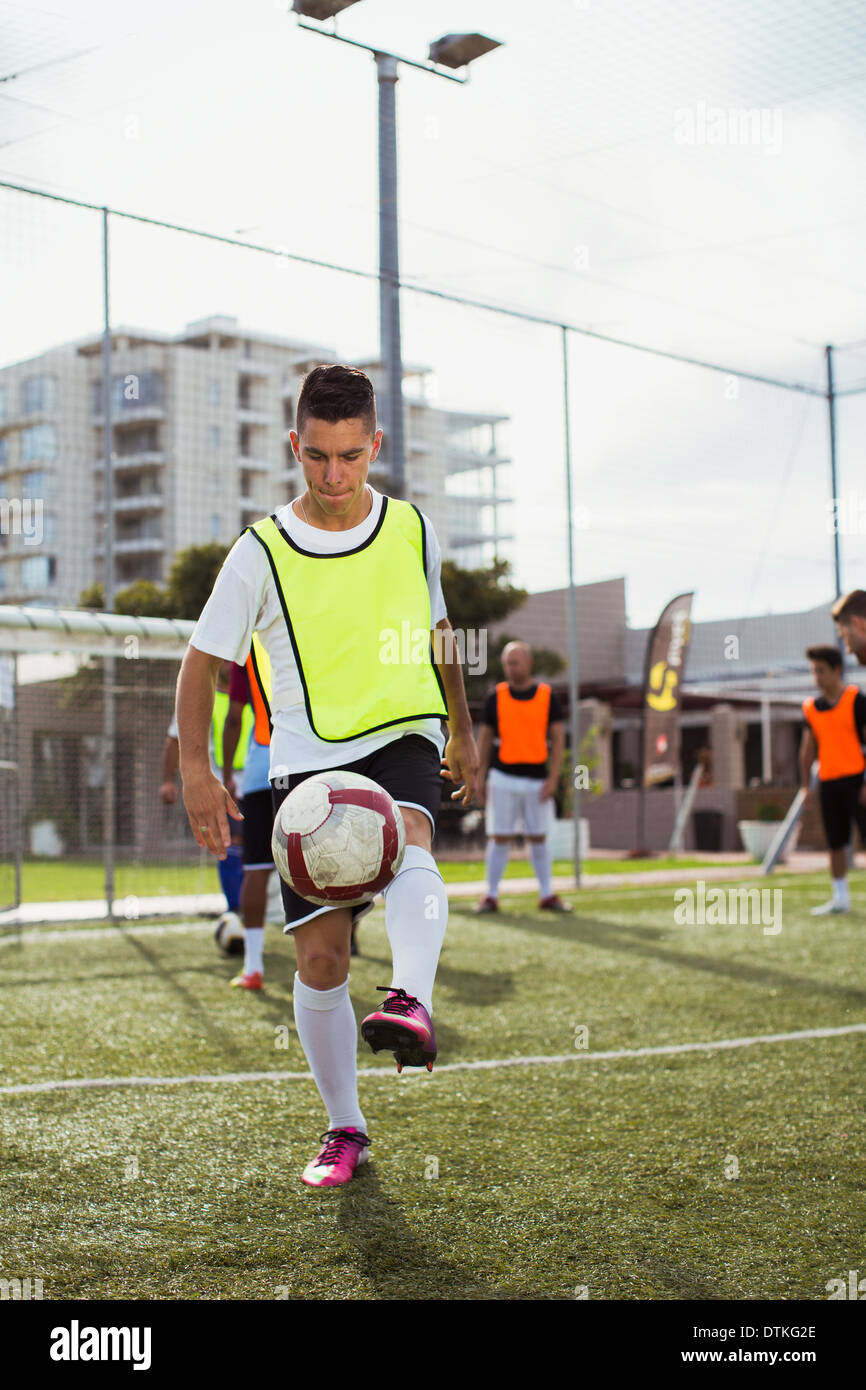 Soccer player training on field Stock Photo