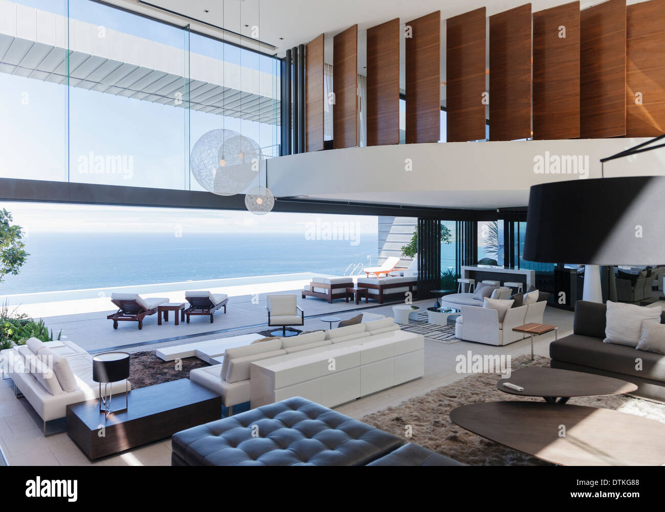 Modern living room overlooking ocean Stock Photo - Alamy