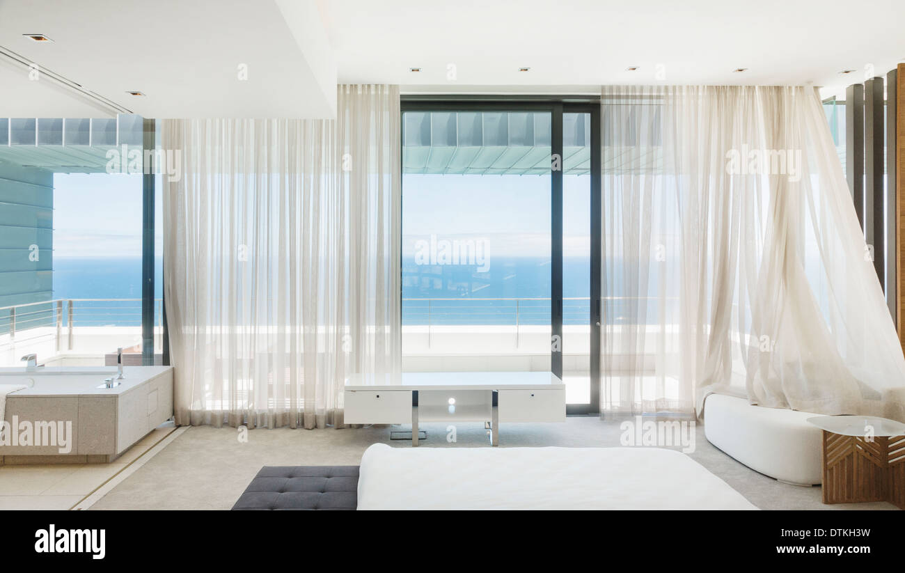 Modern bedroom overlooking ocean Stock Photo