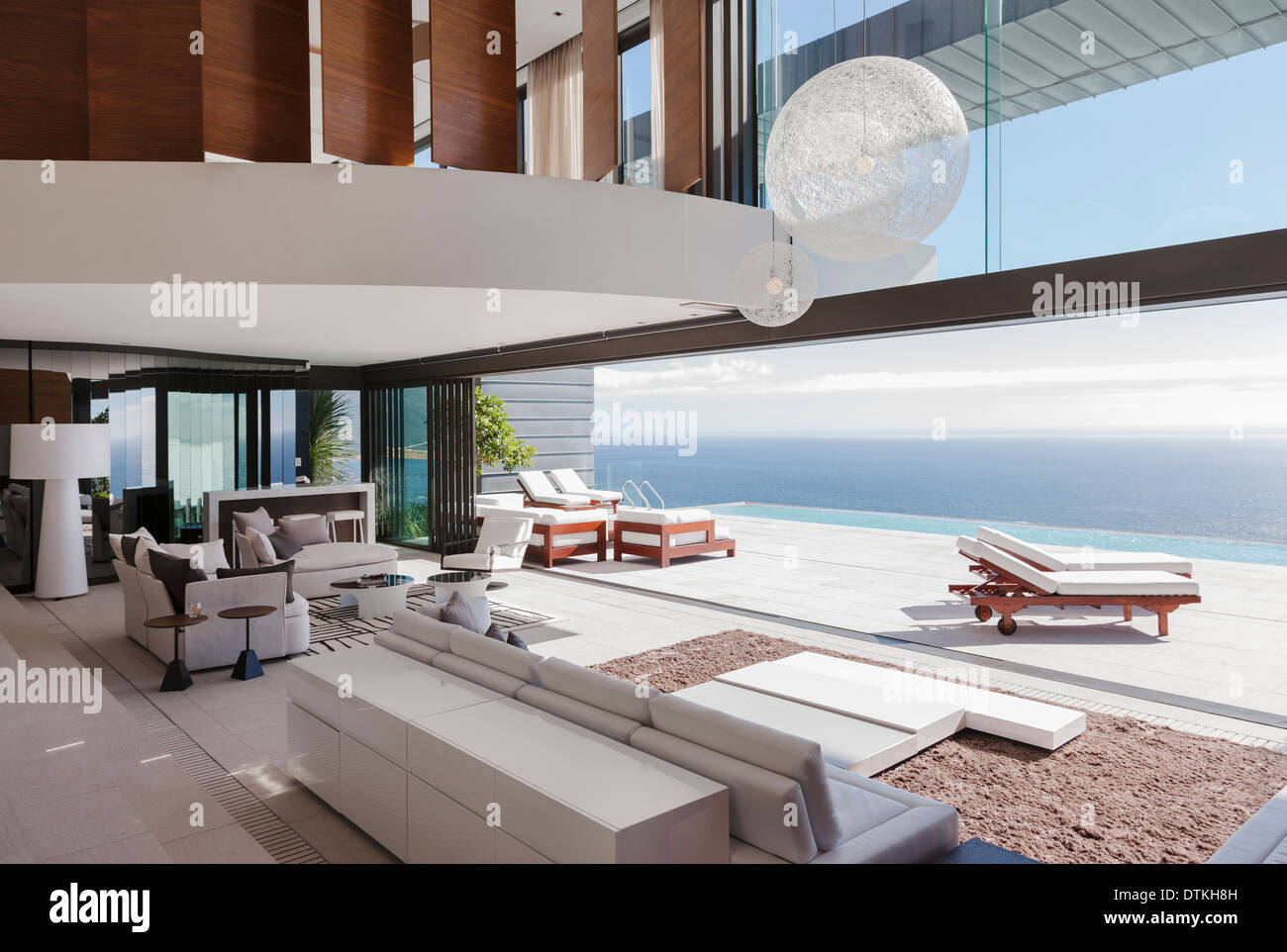 Living room in modern house overlooking ocean Stock Photo