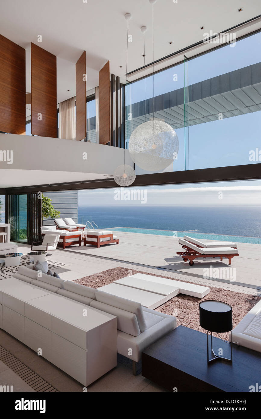 Living room in modern house overlooking ocean Stock Photo - Alamy
