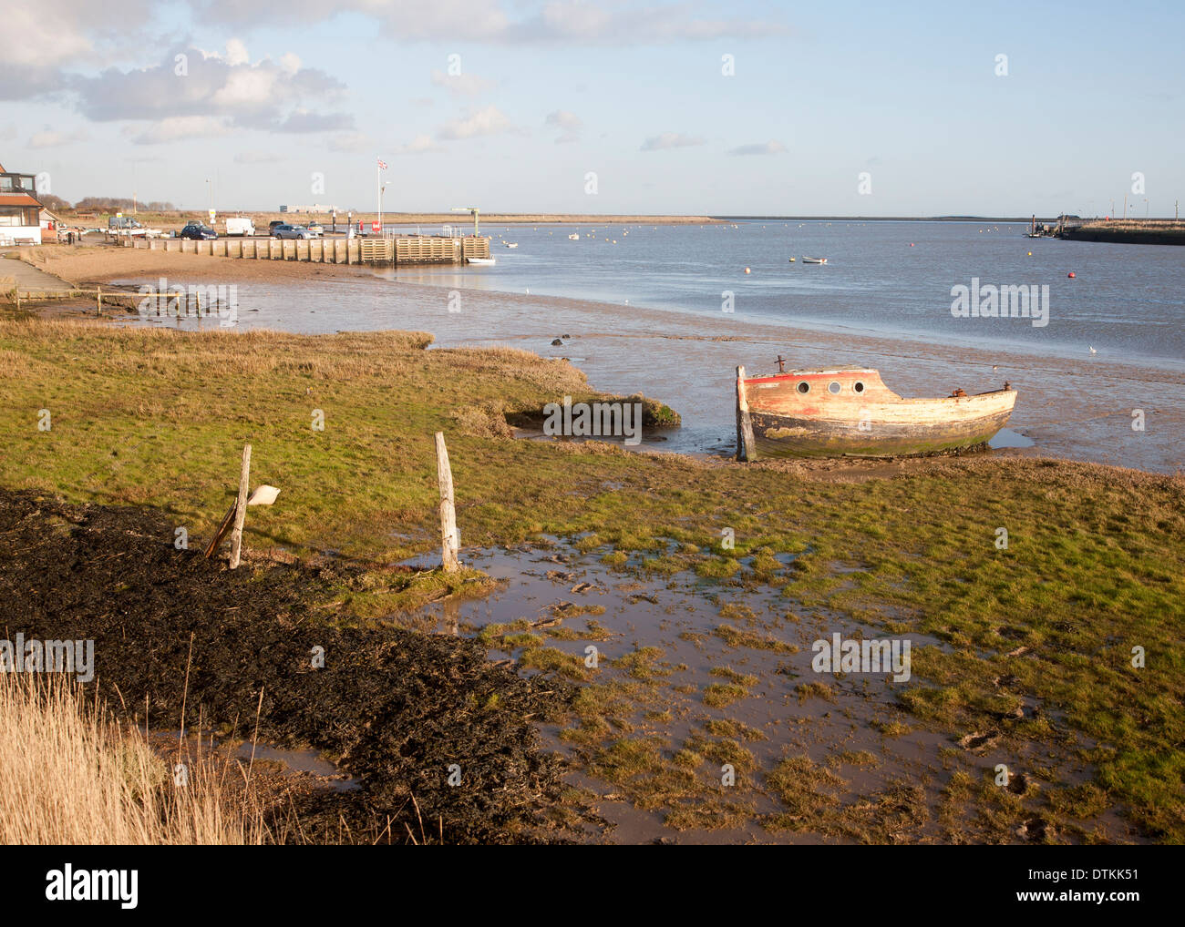 Abandoned old wooden boat rotting on the shoreline on the River Ore at Orford, Suffolk, England Stock Photo