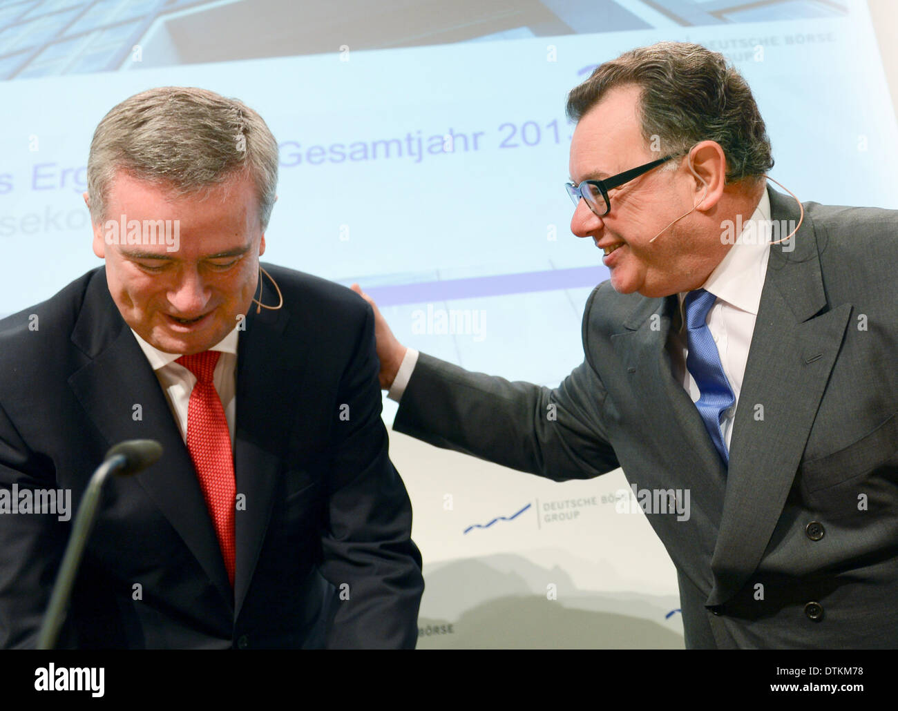 Frankfurt Main, Germany. 20th Feb, 2014. CEO of Deutsch Boerse Reto Francioni (R) pats CFO Gregor Pottmeyer on the back during the annual figures press conference in Frankfurt Main, Germany, 20 February 2014. The German Stock Exchange barely profitted from the record increases on the stock market last year. The bottom line was actually a decrease of more than a quarter to 478.4 million euros. Photo: ARNE DEDERT/dpa/Alamy Live News Stock Photo