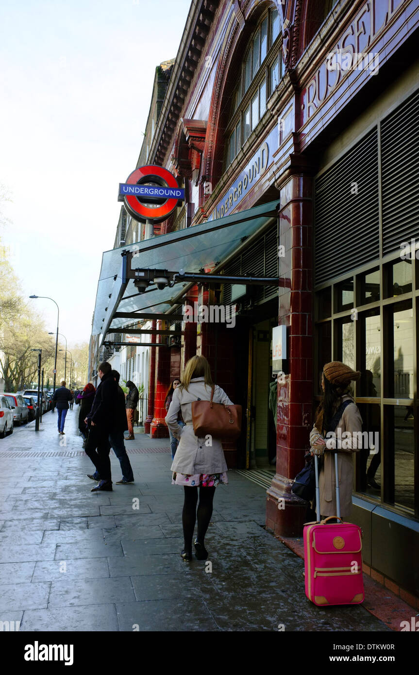 Woman tourist with suitcase waiting outside Russel Square underground Station Stock Photo